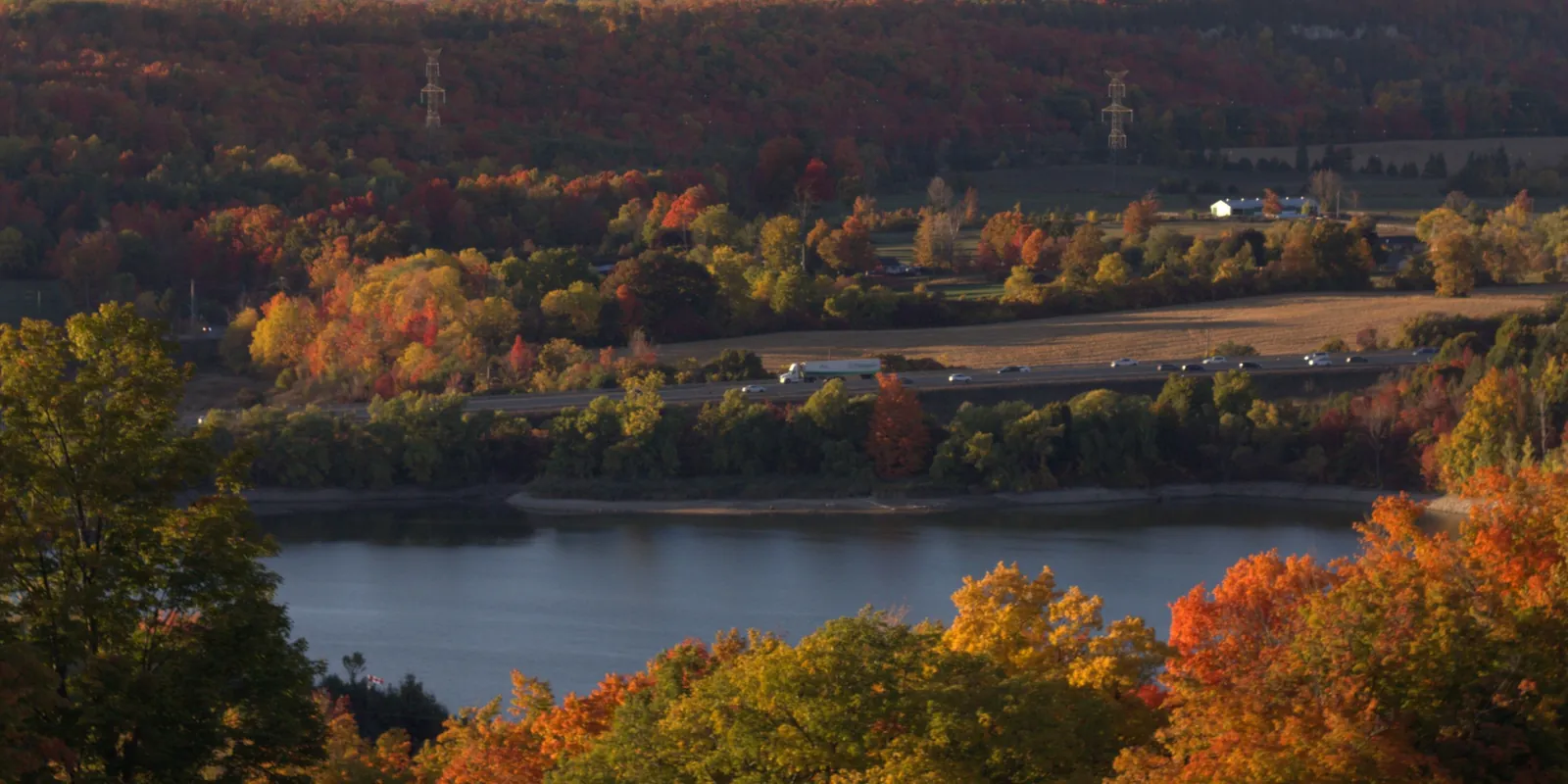 A valley and reservoir framed by autumn woodland in Halton Hills