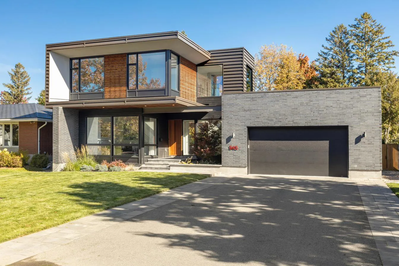 A contemporary two-storey home with grey brick and wood detailing